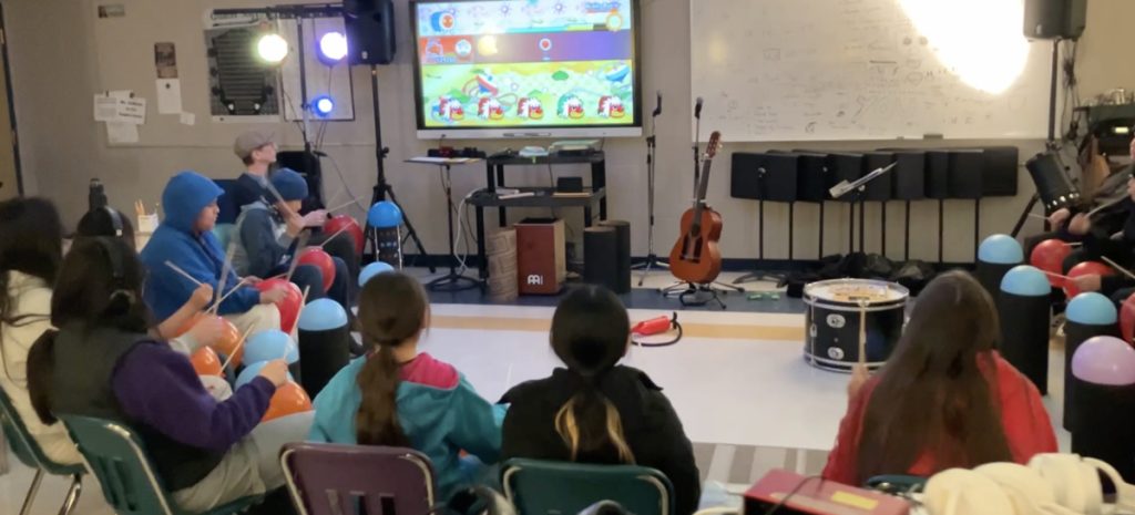 School group playing along to a beatmap on screen.